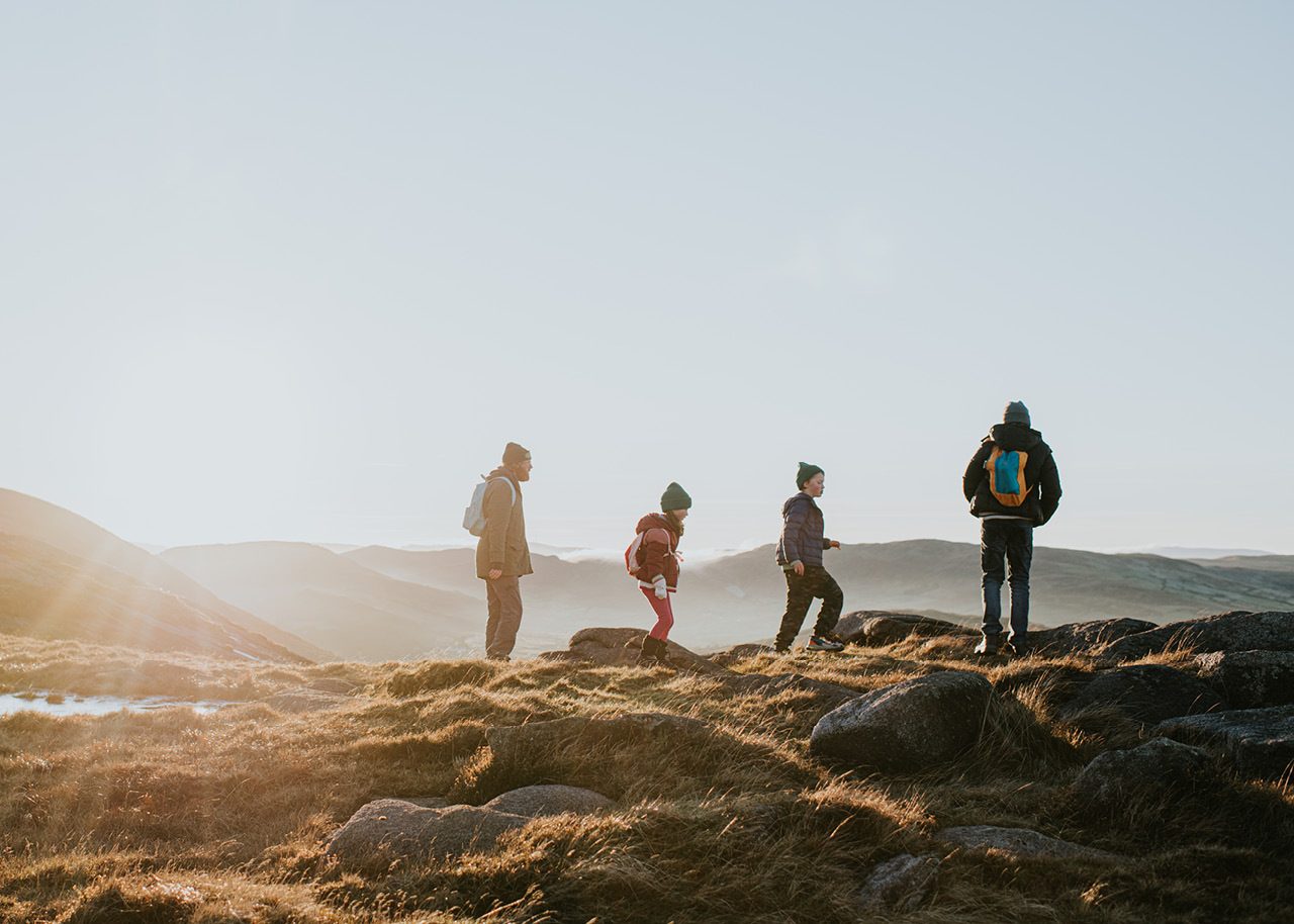 Family hiking on top of a mountain